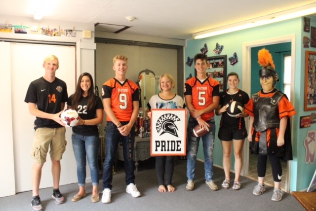 people wearing jerseys and holding sign